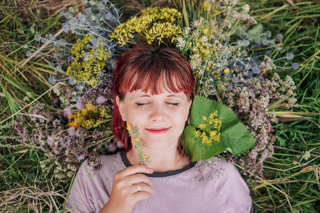 woman finding joy laying in flowers